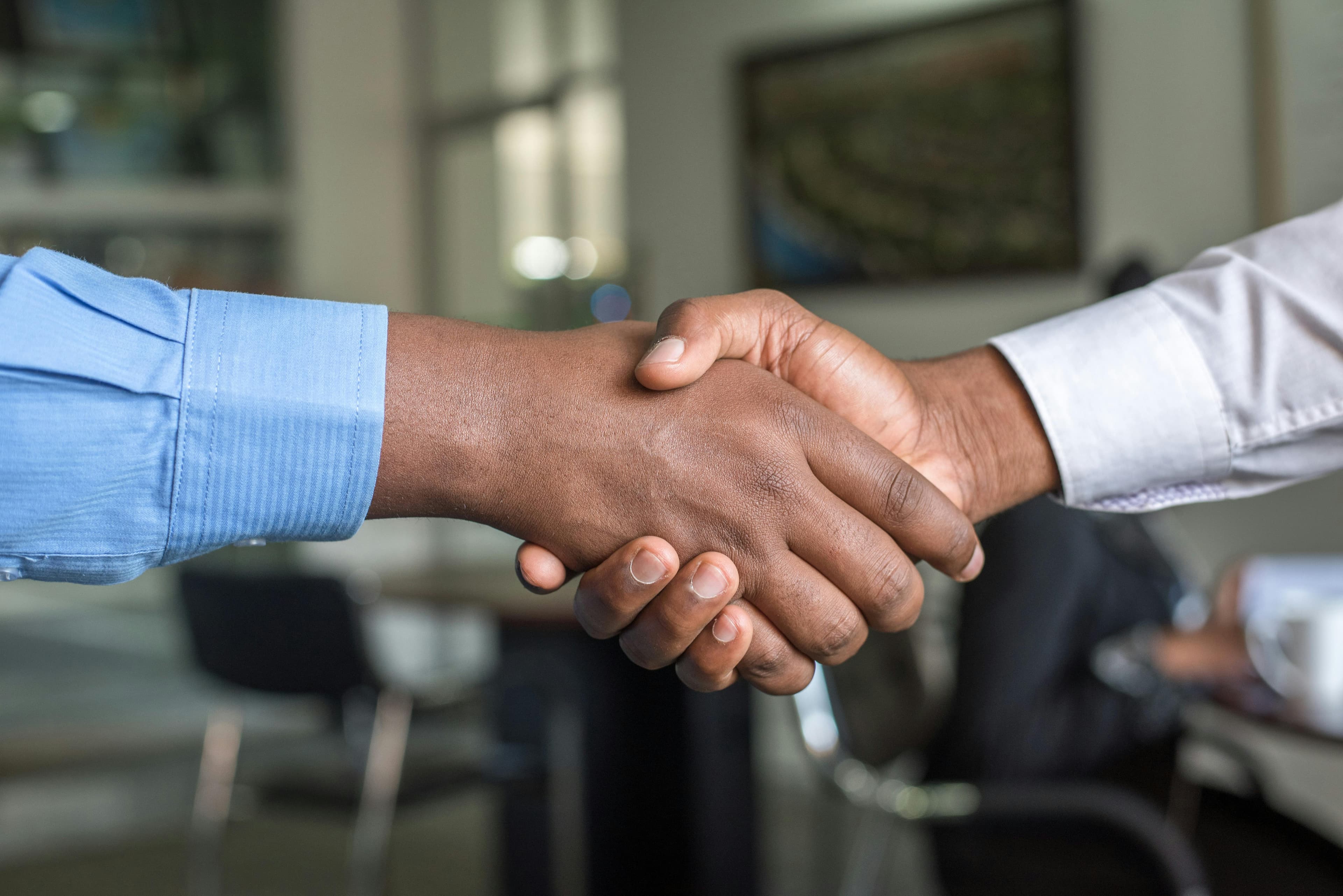 Two business leaders shaking hands over a deal